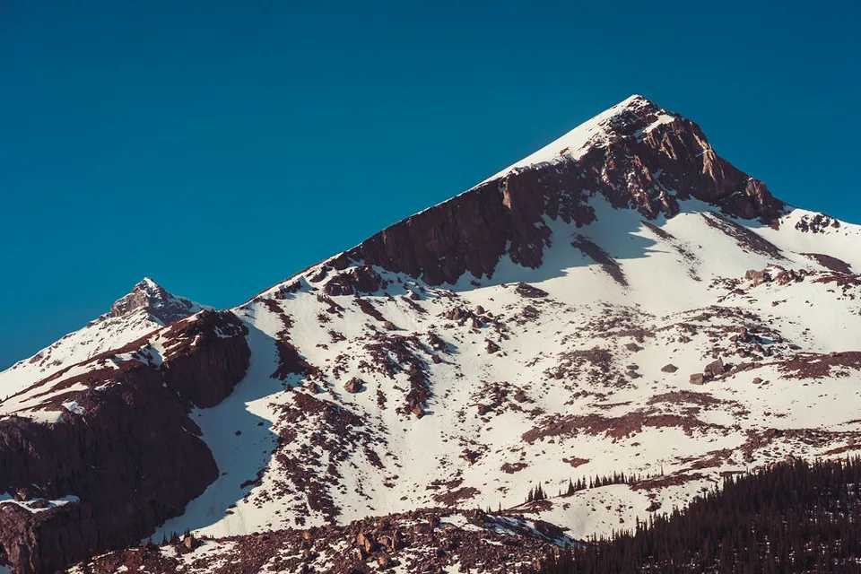 A rocky, snow-capped peak against a clear blue sky, Banff, Alberta
