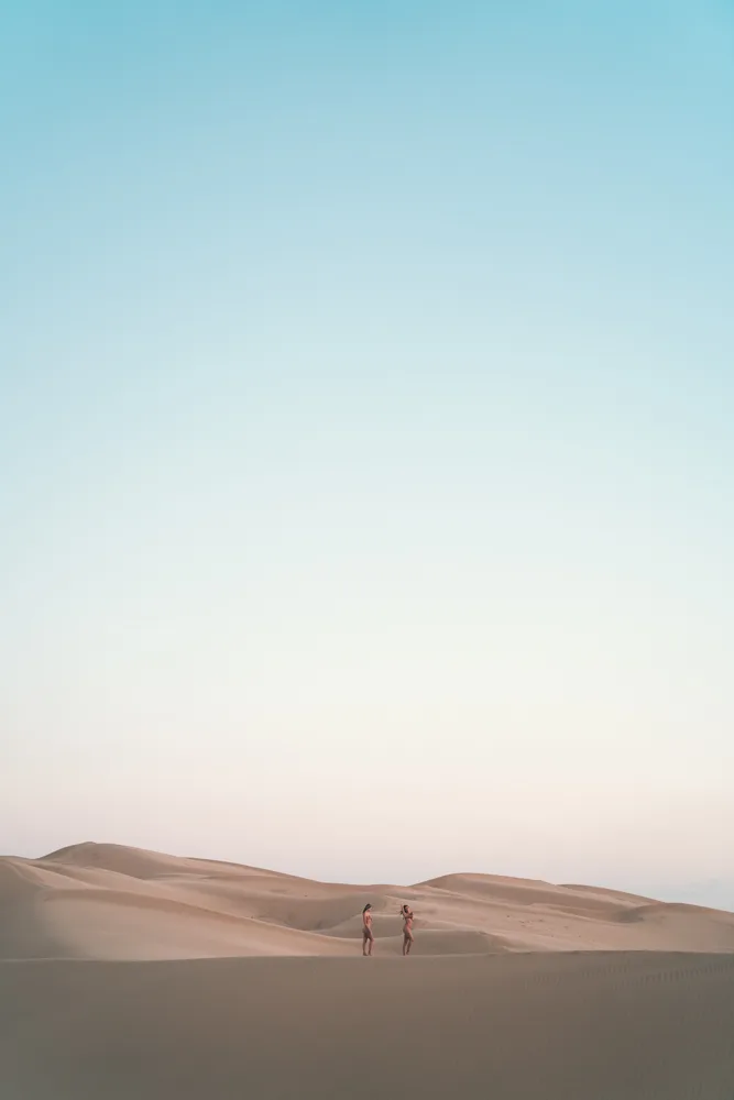Two distant figures on a dune under a pastel sky, Glamis