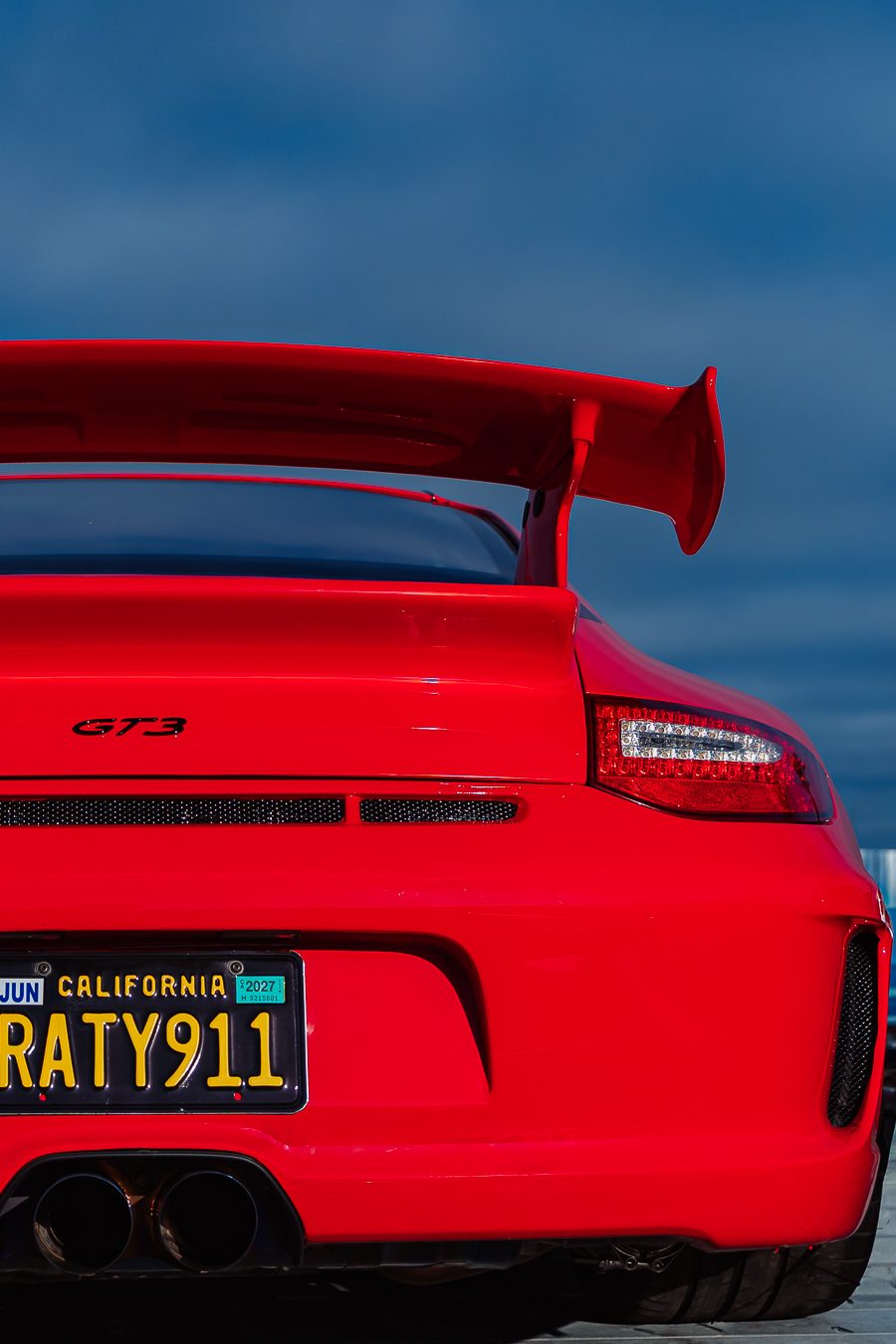Guards Red Porsche 911 GT3 rear spoiler — automotive photography Newport Beach