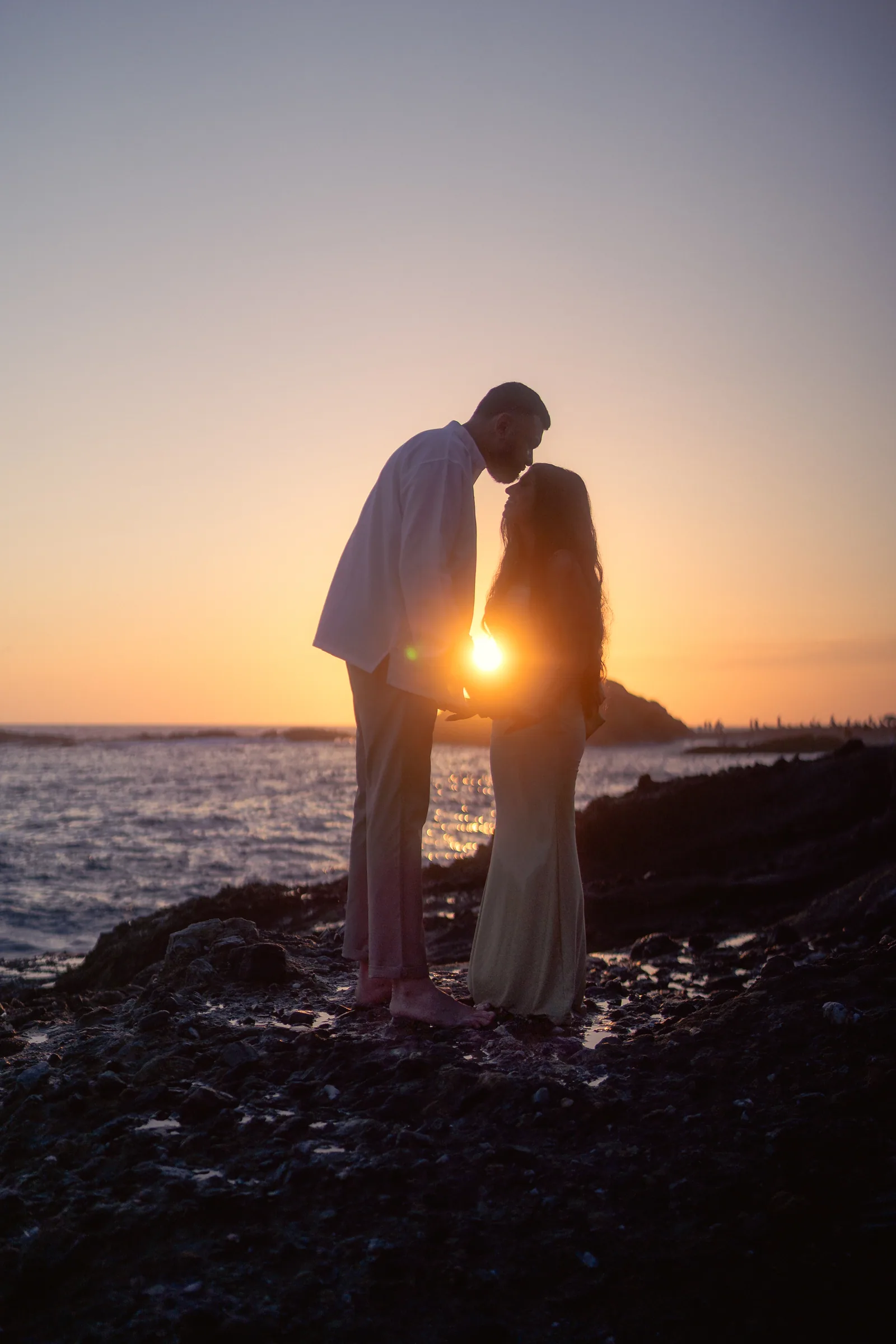 Ronak and Khushbu silhouetted against the sunset at Treasure Island Beach, Laguna Beach