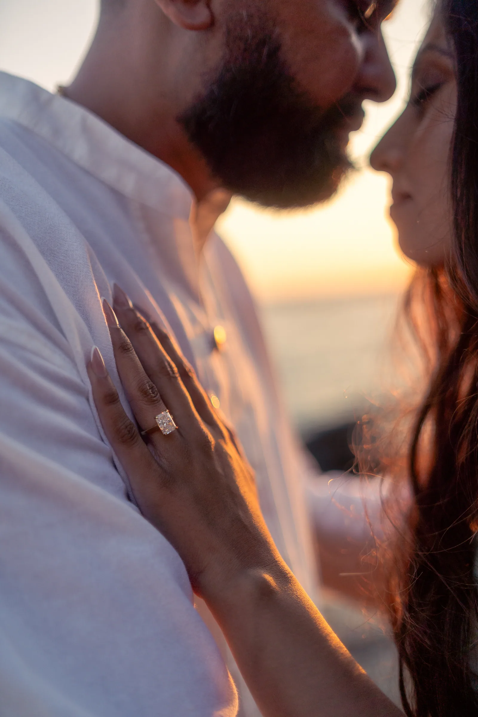 Khushbu's engagement ring, her hand resting on Ronak's chest at golden hour in Laguna Beach