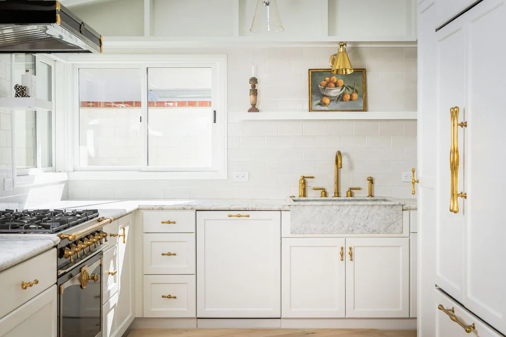 Newport Beach kitchen with panel-ready refrigerator, brass hardware and marble counters