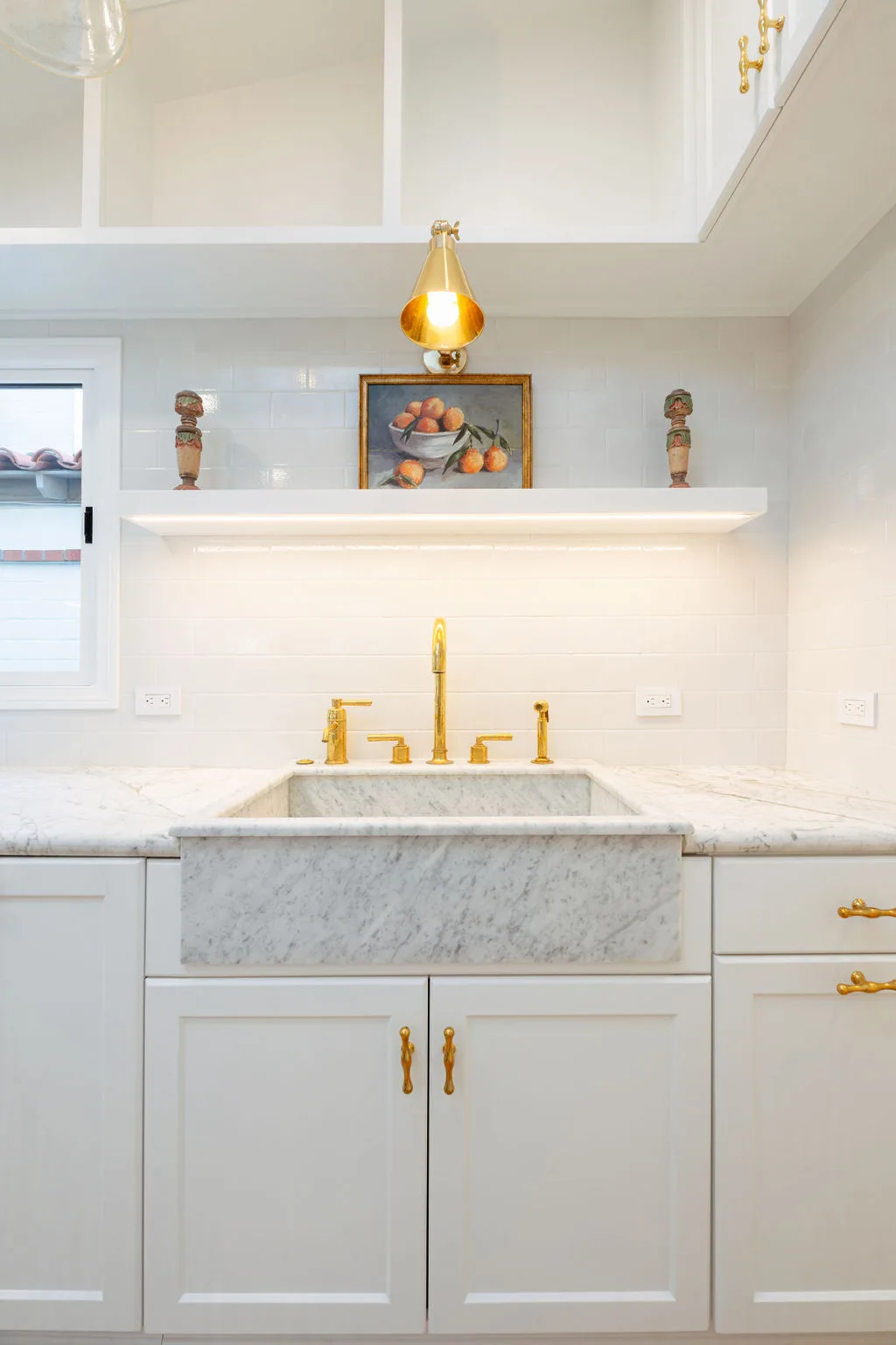 La Cornue range and vent hood centered on white subway tile backsplash